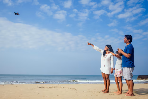 happy-indian-family-are-operating-drone-by-remote-control-beach-goa_175356-8774