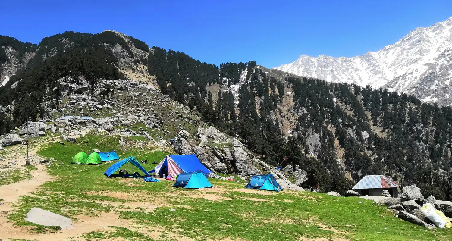 Triund Trek near Dharamshala, Himachal Pradesh Camping tents on Triund ridge with mountain views near Dharamshala
